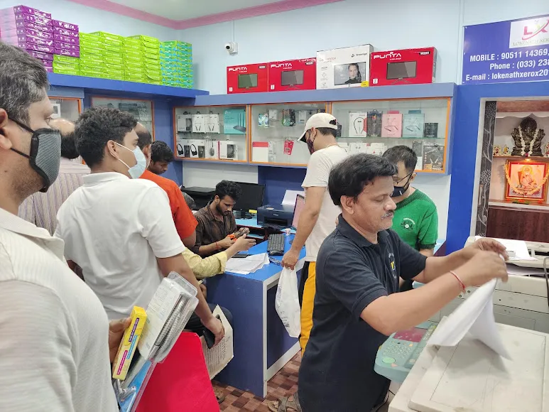 Customers being served at the Lokenath Infotech counter