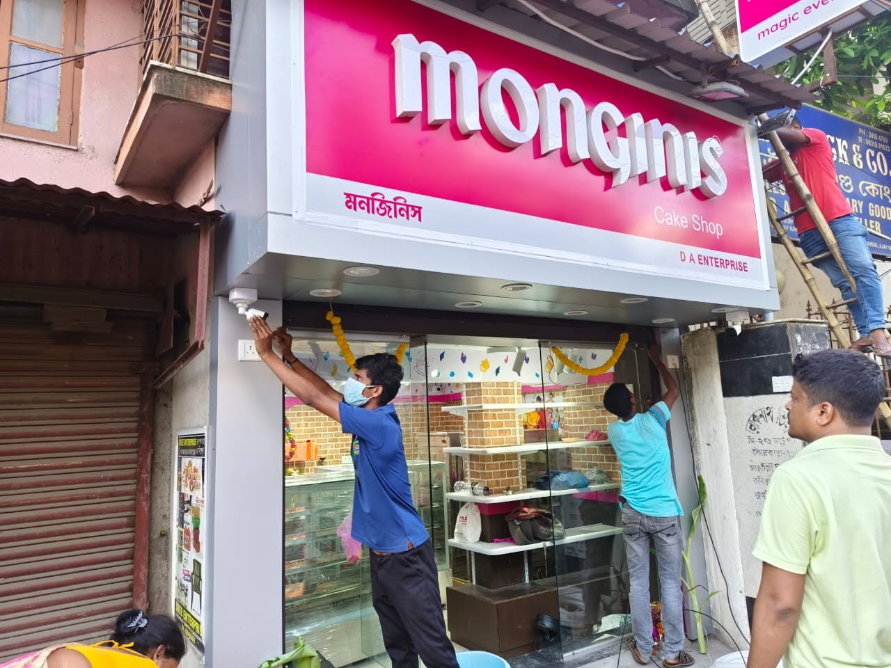 Lokenath Infotech technicians installing a CCTV camera at a Monginis cake shop