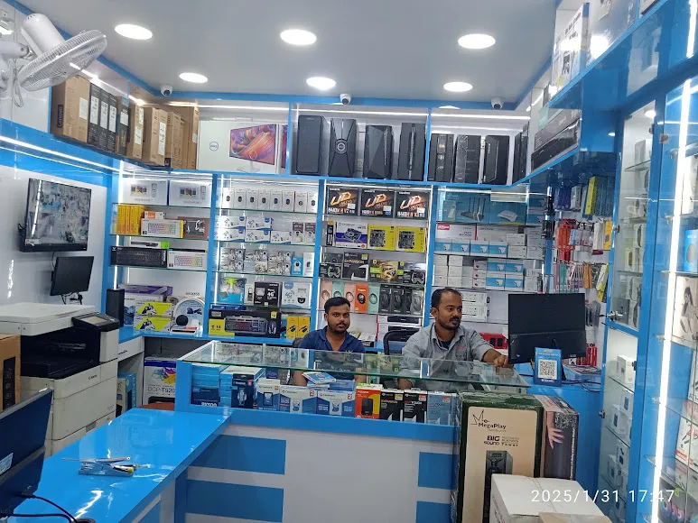 Inside the Lokenath Infotech store showing shelves of laptops and accessories